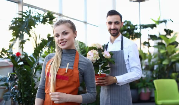 Beautiful Blonde Woman Florist and Man with Flower