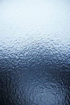 Freezing rain on a window, ice on the windowpane. Frost ice patterns on a window glass. Rime on a windowpane, Bitter cold. Frosted glass window. Ice Background