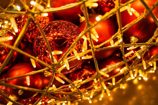 Close up of red Christmas balls baubles. Bokeh garlands. Xmas and holidays concept. Copy space and empty place for text, mock up greeting card