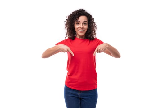 corporate clothing concept. young charming curly brunette woman dressed in red clothes on a white background with copy space