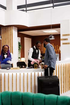 Hotel front desk staff assisting guests