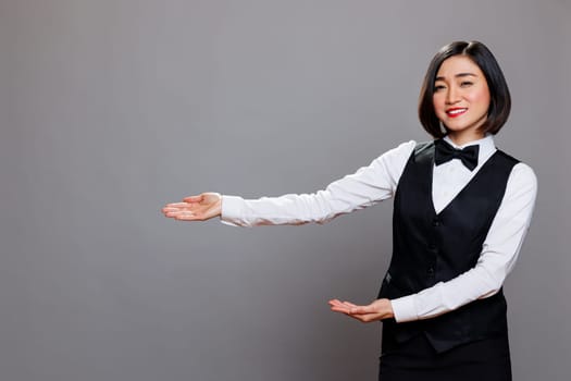 Waitress pointing with hands to right