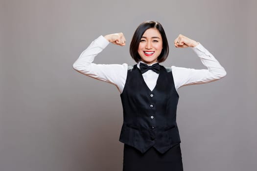 Smiling waitress showing arms muscles