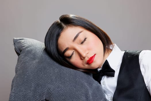 Waitress resting head on pillow