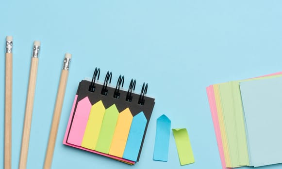 Multi-colored paper sticky notes on a blue background
