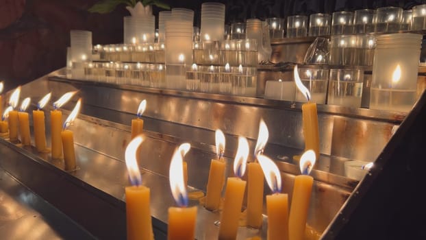 Candles are lit in the Catholic Church.