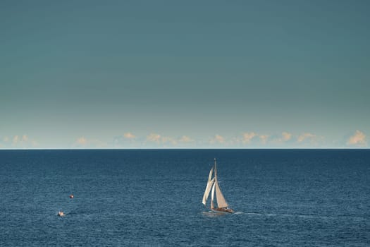 Monaco, lonely vintage sail yacht in sea at sunset, huge sail boat, wealth life of billionaires