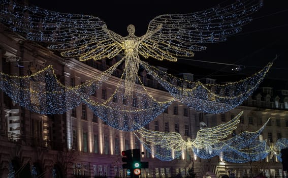 Flying angel Christmas decoration led lights display. Dramatic view of the traditional Christmas decoration lights hanging above Regent Street during dusk.