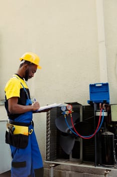 Technician inspecting freon levels