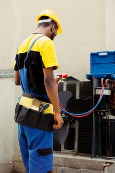 Serviceman doing condenser maintenance