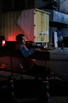 Jakarta, Indonesia - October 4 2023: Night Lights Illuminate Man Seated