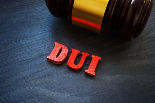 Letters DUI Driving under the influence and hammer.