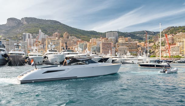 Monaco, Monte Carlo, 29 September 2022 - Water taxi by luxury motorboat on the famous yacht exhibition, a lot of most expensive luxury yachts, richest people, yacht brokers, boat traffic. High quality photo