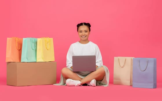 Online Shopping Concept. Happy Joyful Asian Woman With Laptop And Shopper Bags