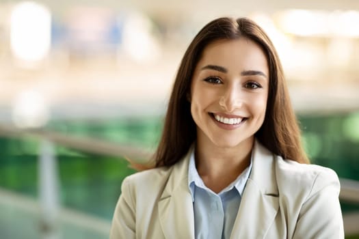 Close-up of a radiant young businesswoman with a friendly smile