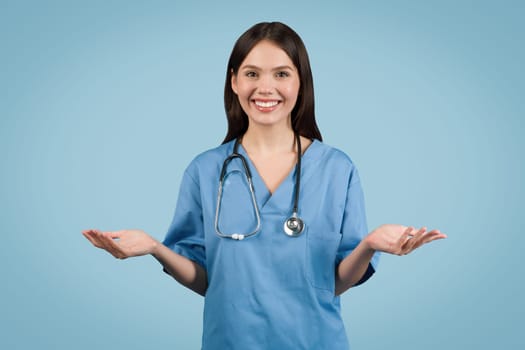 Nurse in blue gesturing, online consulting on blue backdrop