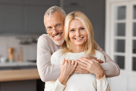 Happy elderly man and woman embrace and enjoying quality time