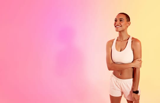 Contented young woman in sportswear stands with arms crossed, smiling confidently