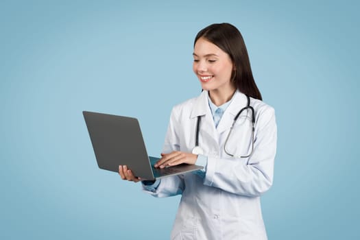 Focused doctor using laptop, technology in healthcare