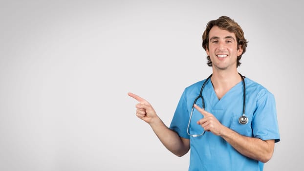 Nurse in blue pointing to side, informative pose