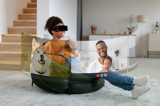 Black woman wearing virtual reality glasses communicating with family indoors