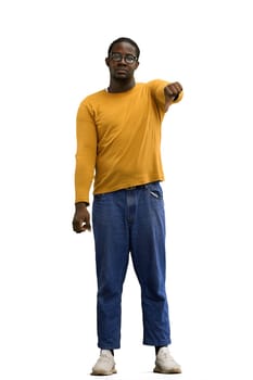 A man in a yellow sweater on a White background shows thumbs down