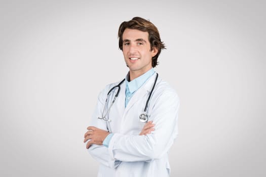 Confident european male doctor with arms crossed smiling