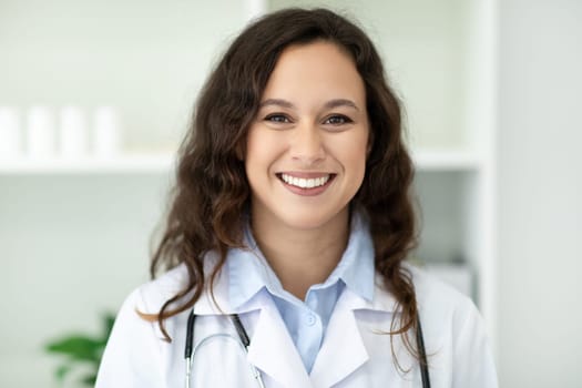 Closeup of cheerful young european woman doctor posing at clinic