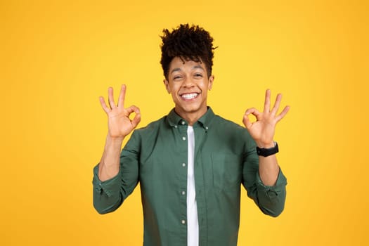 Positive young black guy showing okay gesture