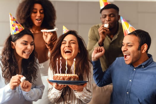 Diverse friends united in birthday celebration enjoying party together indoors