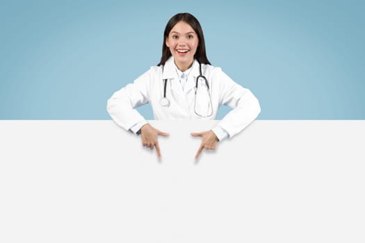 Excited doctor pointing down to blank space, banner