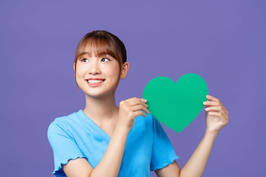 Portrait of cheerful person hold heart postcard toothy smile isolated on violet color background