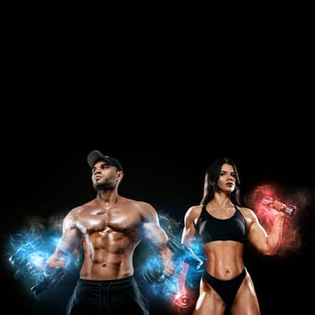 Muscular fitness sports man and fit woman, atletes with dumbbell in fitness gym. Energy and power. Ice and fire.