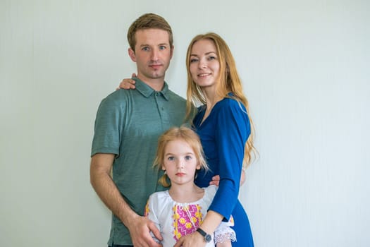 Portrait of a young Russian family with a young daughter.