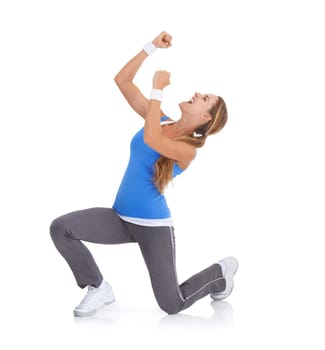 Excited woman, fitness and fist pump in celebration for winning isolated on a white studio background. Female person or athlete smile in relief for prize, achievement or good news on mockup space