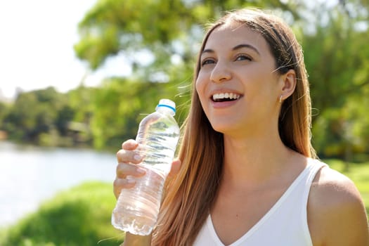 Close-up of beautiful girl drinking fresh water outdoor