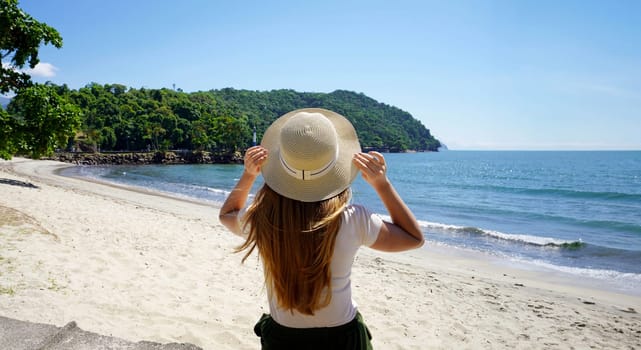 Holidays in Brazil. Panoramic banner view of traveler girl on Ubatuba tropical beach, Brazil.