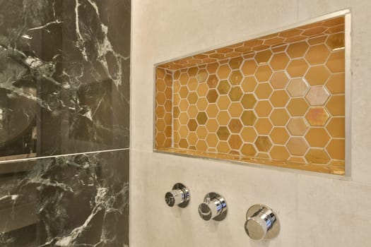 a bathroom with a shower and a honeycomb tile
