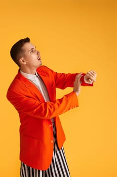 funny man in orange jacket on orange background.