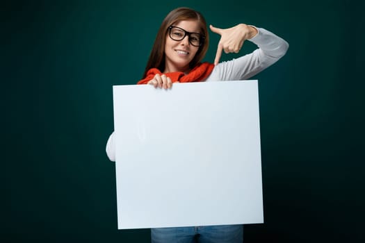Cute young woman in glasses holds a board and shows business tasks on it