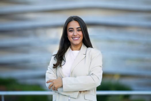 Portrait Of Confident Arabic Businesswoman Posing With Folded Arms Outside