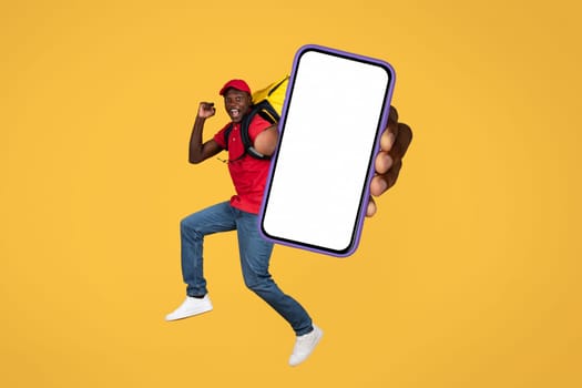 Happy young african american delivery man showing phone