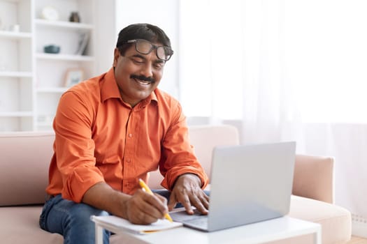Middle aged eastern man have online lesson, using laptop