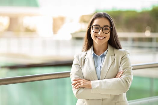 Confident young businesswoman with a bright smile wearing glasses