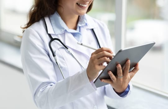 Doctor hands using digital tablet, woman doc have online appointment