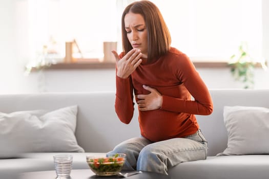 Pregnant Woman Suffering From Toxicosis Having Nausea During Lunch Indoor