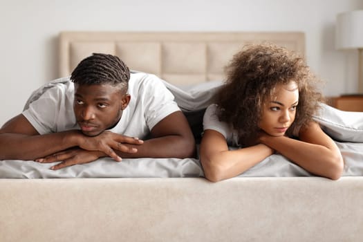 Black Man And Woman Looking Away Sulking Lying In Bed