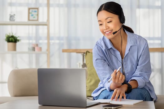 Positive millennial chinese woman working or studying from home