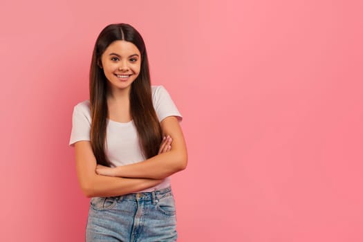 Confident teen girl smiling standing with arms crossed and looking at camera