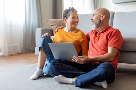 Senior Man And Woman Having Fun With Laptop At Home